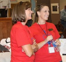Cindy Simpler, left, and Hannah Rainwater enjoy the bidding for the Grand Cherokee that netted Greer Community Ministries $2,250 at Big Thursday.
