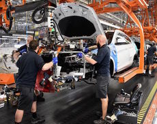 Assembly team members work on the 3.5 millionth BMW.
 