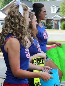 Cheerleaders greet customers to the Clock Restaurant Monday during their fundraiser.