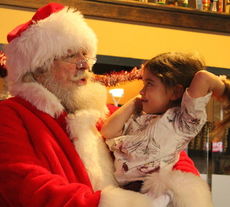Santa Claus played the perfect set up guy for the reunion of Sgt. Cecilia Hoffhaus with her husband, Staff Sgt. Jeff Hoffhaus, and their daughter, Ryann, 3.
 