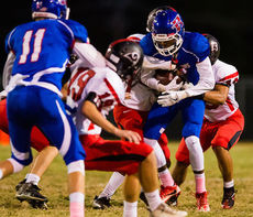 A Riverside ballcarrier protects football from grab-happy defenders,
 