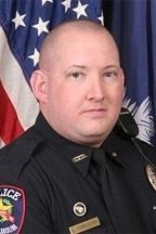 The before photo of Sgt. Chris Forrester. It is still on the Greer Police Department's website.