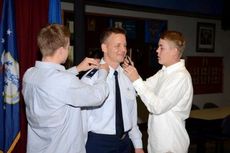 Brig. General Scott Kelly’s sons, Grant, left, and Sean, have his one star rank pinned on him indicating he is now a general officer.