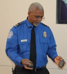 Eddie Mars, a TSA supervisor at GSP holds two military-type grenades that have been hollowed out.
 