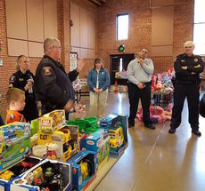 Lt. Jim Holcombe explains the procedure for helping children find a selection of toys they want.
 