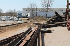 The tracks and railroad ties are separated for removal and transportation off site.