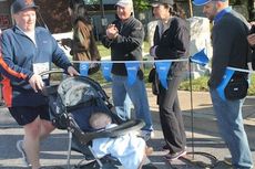 A participant took the opportunity to give a baby a long walk. 