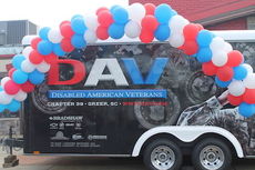 The DAV trailer with red, white and blue balloons was the setting at Ryan's for a $500 Ovation Brands donation to the military organization.
 