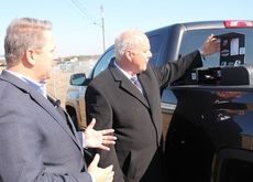 CPW Commissioner Perry Williams, an advocate for alternative fuels, gives David Benner, left, of Mainstay Fuel Technologies,  a look at where CNG will be fueled in his newly acquired GMC factory-produced alternative fuel vehicle.
 