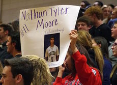 Signs memorializing Nathan Tyler Moore were held by spectators and posted throughout the Blue Ridge High School gymnasium Tuesday night.
 