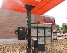 A canopy provides shelter for customers ordering in the drive-thru.
 