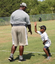 Kyle Jackson, 6, son of Greer defensive line coach Rashaad Jackson, is practicing a slap drill the players practiced a few minutes before. 
 