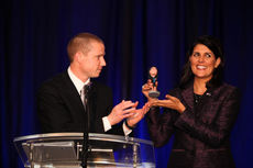 Governor Nikki Haley, tonight's keynote speaker, laughs as she sees Allen Smith prepare to present her with a bobblehead likeness. Nigel Robertson of WYFF was the master of ceremonies.