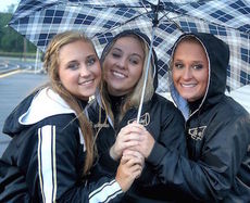 These high school cheerleaders send a clear message what kind of attire is best to wear and bring to keep dry for this week's high school football games.
 