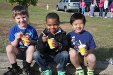 Zack, Christopher, and Chynue enjoy a treat from a truck that transports snow cones.