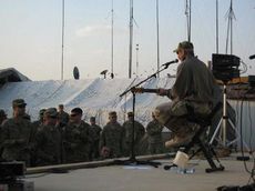 Aaron Tippin entertains the troops overseas as part of the USO shows. Tippin began performing for the troops when Bob Hope invited. Tippin has visited troops in harm's way since. Tippin is photographed at one of his visits to Afghanistan in this photo.