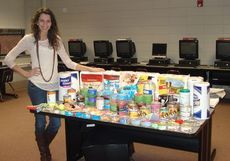 Alyson Craig, president of the Blue Ridge High School FBLA chapter, shows some of the items donated to the Greenville Humane Society.