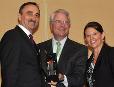 Lewis E. Leibowitz, NAFTZ Board Chairman, presents the 2009 Exporter of the Year Award to Josef Kerscher, President of BMW Manufacturing in Greer. Courtney Gregoire, Director of National Export Initiative, International Trade Administration, was also an award presenter.