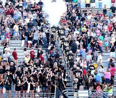Greer fans celebrate the Yellow Jackets arrival into the stadium through the traditional smoke. 