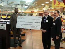 Anthea Jones, SVP of Operations and President of BI-LO, presents a check to Keith Miller, president of Greenville Technical College, standing with Michael Byars, Chairman of the Board, BI-LO Charities and former president and CEO of the company.