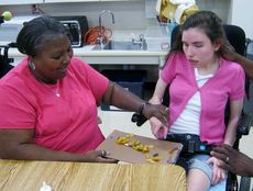  
Washington Center Paraprofessional Rhonda Dreher assists student Sara Allen in creating her own “Sara-saurus” during the class’ recent dinosaur project.
 