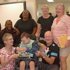 Washington Center student Evan Burns (seated) and family are welcomed to the 2013-14 school year by new teacher, Claire Blouir and staff.