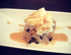 Budin de Pan (bread pudding) with vanilla ice cream and sauce.
 