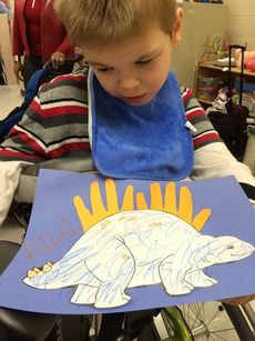 Washington Center at Hollis student Eliah Peart is pictured with his dinosaur project during Cayce Campbell's class unit.
