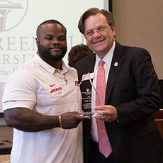NGU President Dr. Gene C. Fant, Jr. presents Carl Dukes with the 2018 Young Alumnus of the Year Award.