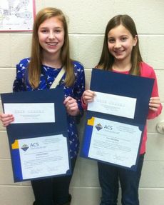 Lisa McClellan, right, received the first place and second place went to Lauren Fallow, left, in poetry contest.