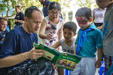 Cmdr. David Krause, from Greenville and a cardiologist, reads to Vietnamese children.
 