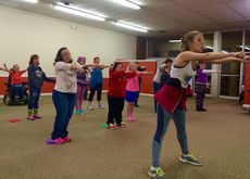 Co-founder Kelsey Crum teaches the students a flash mob dance they will perform Saturday at the Fountain Inn Christmas Festival.
 