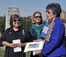 The Chapter of the DAR met at Mountain View Cemetery to recognize the completion of one of their major projects: researching veterans buried at four Greer cemeteries. Chapter regent Zoe Carlson (left) presented the roster to special guest Dianne Culbertson, state vice regent for South Carolina.
 