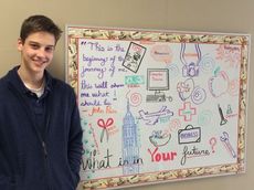 GTCHS Junior, John Price, stands before a quote from his state winning poem for the NCDA's Poster & Poetry Contest.