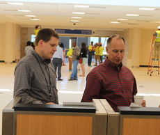Dave Edwards, right, GSP Airport President/CEO and Scott Carr, VP/Commercial Business and Properties, are deciding where the ticket counter will be set before passengers head to the TSA centralized screening checkpoint behind them.
 
 
