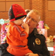 Police enjoyed holding infants while a list of suggested toys were collected.
 