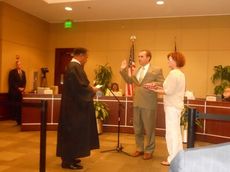 City Councilman Jay Arrowood, representing District 1, is sworn in for his third term. Municipal Judge Henry Mims presides. Arrowood's wife, Lisa, holds the Bible.

 

 