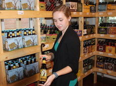 Katie Ellenburg holds a bottle of wine produced by Bottle Tree.
 