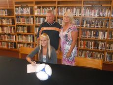 Kendall Strawhorn becomes the first Greer High School girls soccer player to sign a grant-in-aid to continue her career in college. Strawhorn signed with Spartanburg Methodist College as her parents, Ken and Donna, observe the ceremony.