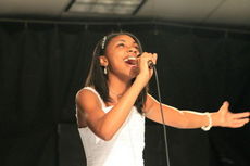 On February 21, Riverside Middle School held its Family Night that featured booths from the Model UN students' Festival of Nations and a student talent show. The talent show was emceed by eighth-grade students Gail Holland and Kinsley Yant. Taking home the first place trophy was Kennedi Hunter, pictured here, singing “Because of You” by Vicki Yohe. Second place went to Carol Lee who played Aram Khachturian's 