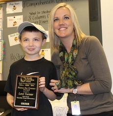 On the home page is Levi Turner with his third grade teacher, Mrs. Candace Grugan.