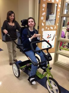 With the assistance of Physical Therapist Lisa Porter, Washington Center student Sara Allen receives motor skill benefits from an adapted bicycle funded by a Macy's Foundation Grant.