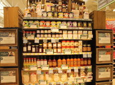OB’s Irie Pepper Sauce and Marinade is shown on the far left on the second from bottom shelf. 
 