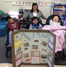 Washington Center teacher Sharon Russo displays the results of her class science project with students (left to right) Iver Solis, Jason Moo and Mya Ballenger.