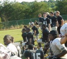 Players await their cue to get into some contact during spring practice at Greer High School. 