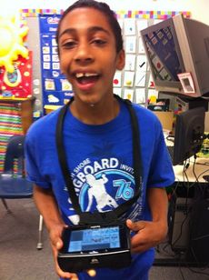Washington Center student Frankie Robinson has fun using a DynaVox Xpress communication device.