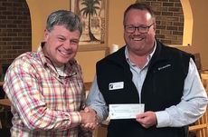 Tony Langford of the Greer Lions Club presents Greer Community Ministries Executive Director Stephen Smith check for proceeds from Big Thursday hot dog summer.
 