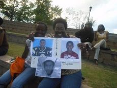 Tena Irby holds a sign in memory of Trayvon Martin during a vigil tonight at Greer City Park's amphitheater. Next to Irby is Mekayla Watson, her great niece,  About 150 attended the peaceful event that feautured community ministers offering prayers.