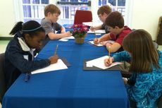 Students in the etiquette workshop took notes and wrote them in worksheets regarding their social skills. The next class will instruct the children on table manners.