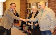 Mr. and Mrs. Glenn Kennemore are congratulated by Greer CPW General Manager Nick Stegall for winning $100 in a drawing among the utlity's eBill program.